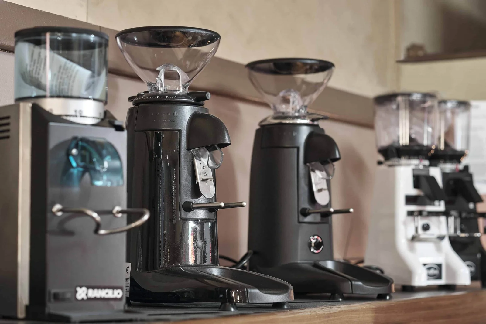A row of espresso grinders on the shop shelf