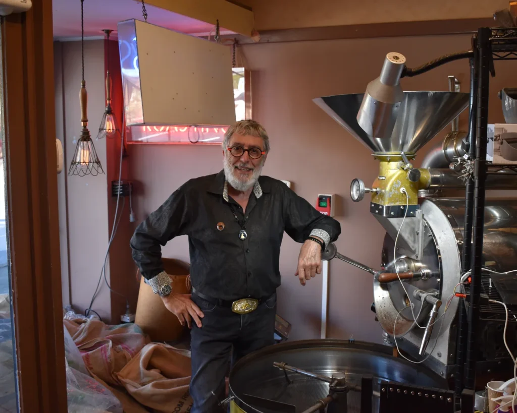 Serge Siboni, founder of Siboni's Coffee, beside the original roaster in Pymble